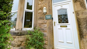 A stone building with a white door labeled "34" and a sign reading "STANG VIEW". - Stang View (Barnard Castle)