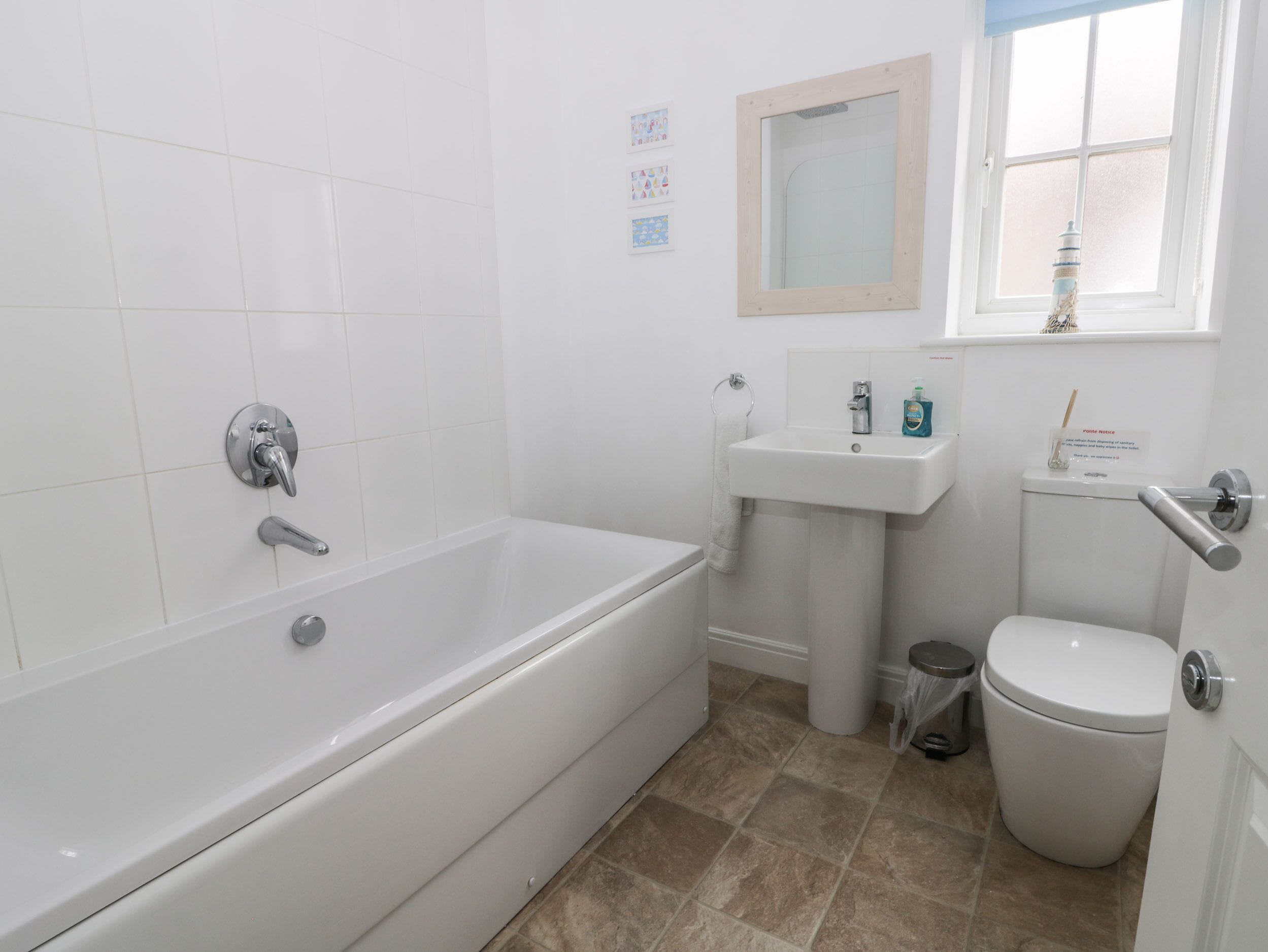 A bathroom with a bathtub, sink, and toilet.
