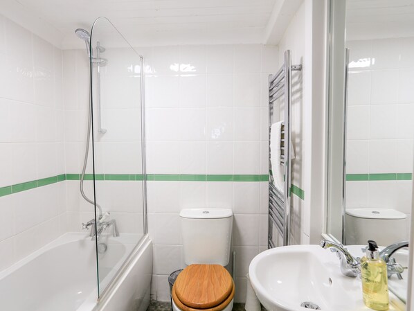 A bathroom with a bathtub, toilet, and sink.