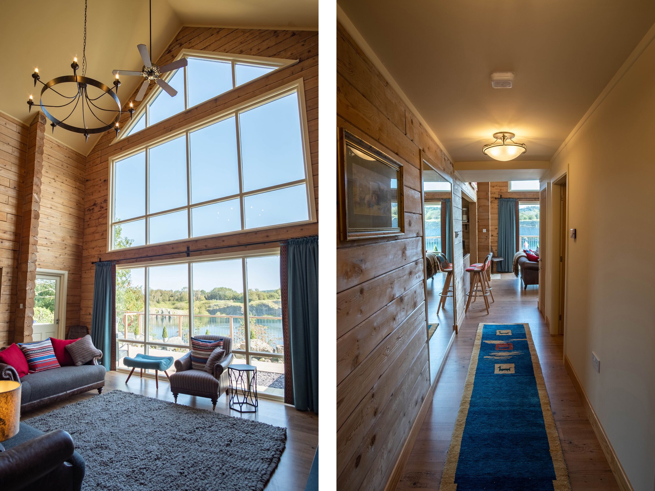 A spacious room with large windows, a chandelier, and a cozy seating area.