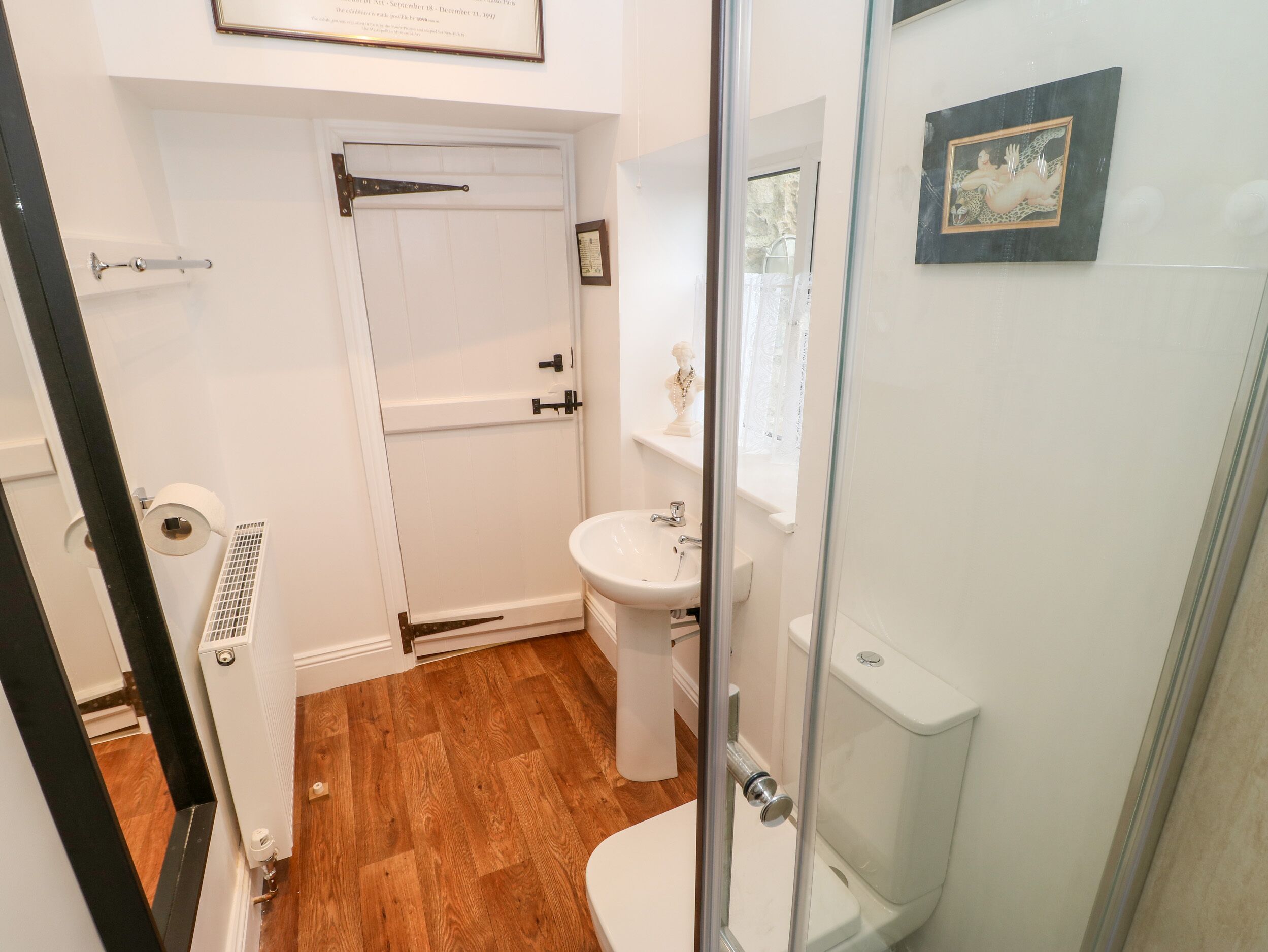 A bathroom with a toilet, sink, and shower.