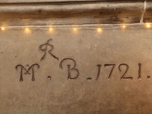 A close-up of a textured surface with the inscription "M. B. 1721." - Millstream Cottage (Hope Valley)