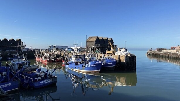 A harbor with several boats docked, a building with a sloped roof, and calm water reflecting the boats. - Lilly Cottage - Fisherman's Cottage Whitstable (Whitstable)
