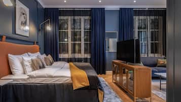 A modern bedroom with a large bed, a TV, and a console table.
