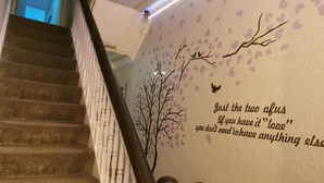 A staircase with a wall mural featuring a tree and a quote. - Immaculate 1-bed Apartment in Blackpool - Sleeps 5 (Blackpool)
