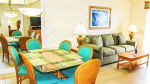 A dining area with a glass-top table and teal upholstered chairs, a green sofa, and a small side table with a lamp. - 2 Bdrm intercostal Water View @ Fort Lauderdale Beach Resort, FL (Fort Lauderdale)