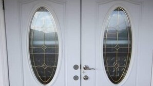 A white double door with a glass panel and a keyhole. - Veronica's - Breathe Easy - Reduit Apartment #1 (Rodney Bay)