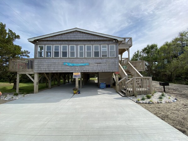 A wooden building with a sign reading 'the Sandbox' and a 'For Rent' sign. - Salvo Sandbox: Ocean-Side, Dog-Friendly Cottage (Salvo)