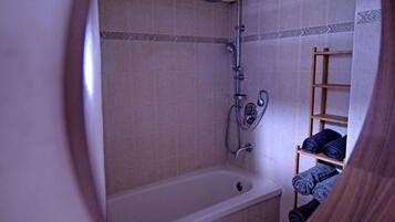 Combined shower/bathtub, towels, soap, toilet paper