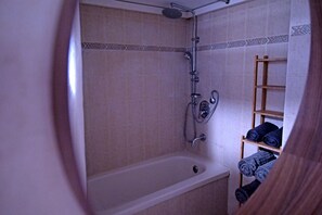 Combined shower/bathtub, towels, soap, toilet paper