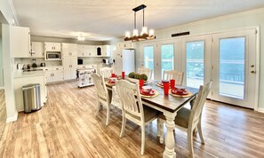 Enjoy meals in the classic kitchen and dining area with a central island and wooden table for four.