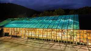 A large glass-roofed building with a parking lot in front. - Celebrate July 4th in the beautiful Smoky mountains!! (Gatlinburg)