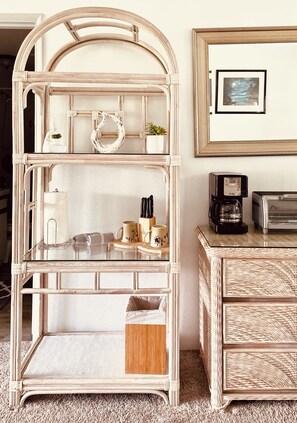 Relax in this inviting space with a central wicker coffee table and a wicker side table, perfect for enjoying a morning coffee.