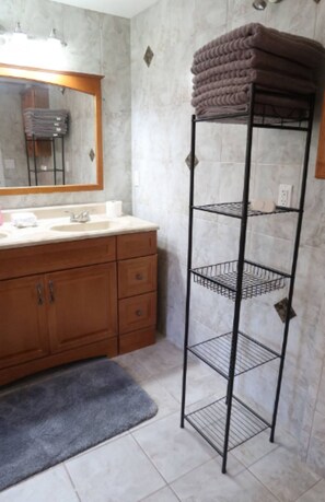 Combined shower/tub, hair dryer, towels, soap