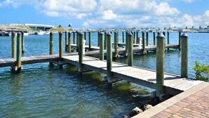 A wooden pier extending into calm water with a clear sky above. - Eisenhower Retreat (Key West)