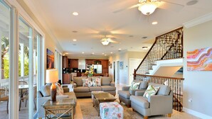 A spacious living room with a sofa set, a glass coffee table, and a dining area with a table and chairs. - Southern Comfor t (Key West)