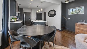 A modern kitchen with dark cabinetry, a central island, and pendant lighting. - Immaculate Meets Comfort! 3 BR Spacious Home! (Nashville)
