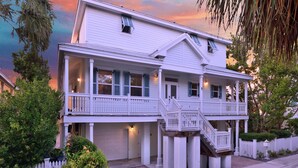 A two-story house with a balcony, a garage, and a staircase leading to the upper level. - Paris Mango (Key West)