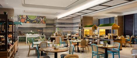 A modern restaurant with multiple dining areas, wooden furniture, and a colorful mural on the wall.