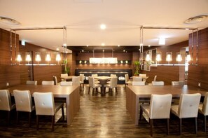 Enjoy meals in a spacious dining area with a central island and multiple seating options.