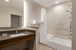 A modern bathroom with a sink, mirror, shower, and toilet. - Fairfield Inn & Suites by Marriott Bonita Springs (Bonita Springs)