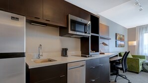 A modern kitchen with a built-in microwave, stainless steel refrigerator, and a coffee maker. - TownePlace Suites San Luis Obispo (San Luis Obispo)