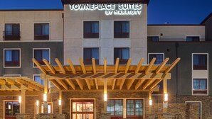 A townhouse-style hotel with a covered entrance, multiple windows, and a sign indicating it is a Marriott property. - TownePlace Suites San Luis Obispo (San Luis Obispo)