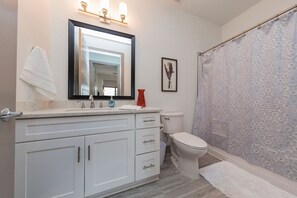 Combined shower/bathtub, hair dryer, towels - 8th South Modern Condo • Near Downtown (Nashville)