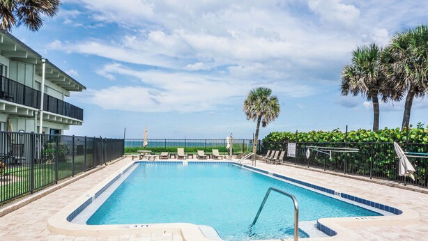 A rectangular swimming pool with a tiled edge, surrounded by a brick deck. - Casa al Mare – Premier "True Beachfront" Living in Vero Beach!  Steps to sand! (Vero Beach)