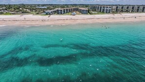 A coastal hotel with a beachfront view, multiple swimming pools, and a sandy beach. - Casa al Mare – Premier "True Beachfront" Living in Vero Beach!  Steps to sand! (Vero Beach)