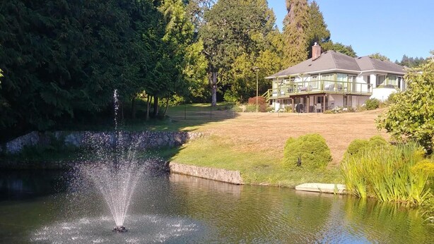 A house with a pond and a fountain. - Dominion Brook Park Vacation Rental - Beautiful suite with garden / park views. (North Saanich)
