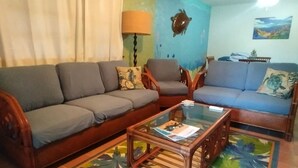 Living area - Hidden by beautiful palm and flamboyant trees but close to restaurants & stores  (Christiansted)