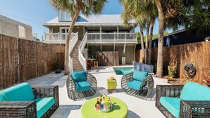A backyard with a pool, wicker furniture, and a wooden fence. - **MAYA’S SECRET TREASURE** Pool & Balcony + Last Key White Glove Service... (Key West)