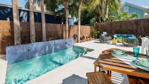 A backyard with a swimming pool, wooden deck, and outdoor furniture. - **MAYA’S SECRET TREASURE** Pool & Balcony + Last Key White Glove Service... (Key West)