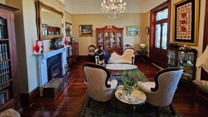 A traditional room with a fireplace, ornate furniture, and a chandelier. - Luxury and heritage hotels in a country mansion built in 1872, 150 yrs in 2022 (Leconfield)