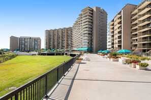 Residents can enjoy a spacious courtyard with a lawn and outdoor seating areas.