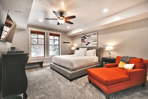A bedroom with a bed, a chair, a desk, a ceiling fan, and a window. - Private Hot Tub|Walk to Town Lift and Main Street | Managed by Park City Lodging (Park City)
