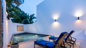 A pool area with lounge chairs and a small hot tub. - Modern Tropical Villa (Koh Samui)