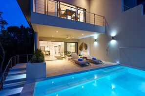 A modern two-story house with a swimming pool, outdoor seating, and a balcony. - Villa Casa Bella - Luxury, Private Pool Villa  (Koh Samui)