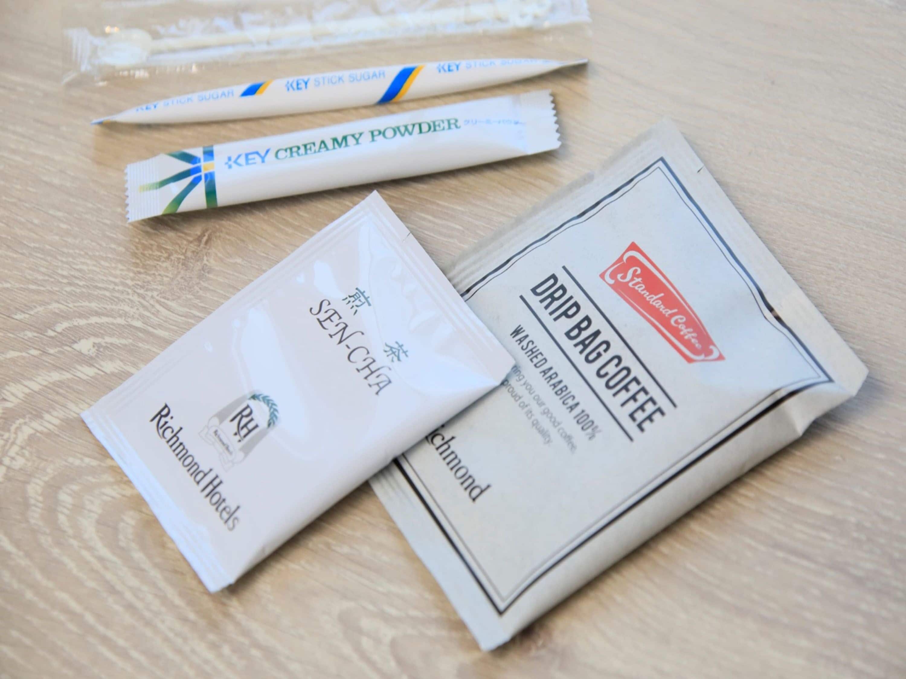 A table with three coffee products: Key Creamy Powder, Sen-Cha, and Drip Bag Coffee.