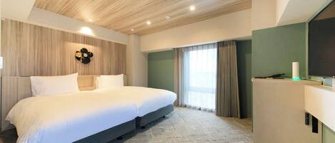 A modern bedroom with a large bed, a wooden ceiling, a green accent wall, and a desk with a lamp.