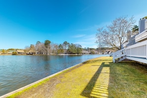 Stroll down to the water's edge from the lush grassy area, surrounded by serene views.