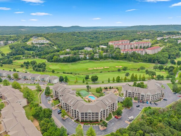 A residential area with multiple apartment buildings, a golf course, and a swimming pool. - Pool View 3BR Condo Near Branson Strip • Walk-In • Golf Course Location • Sleeps 8 (Branson)