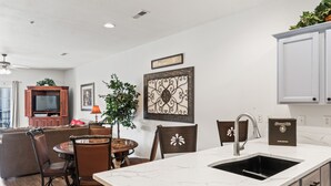 A modern kitchen with a marble countertop, a built-in sink, and wooden cabinets. - 1 Bedroom Condo + Queen Suite (Adjoined Units, Lock-Off Access) (Branson)