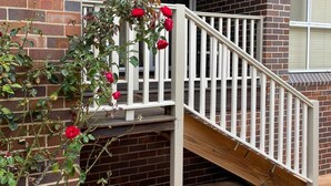 A brick building with a white staircase leading to a porch. - ☘️"KILMEEDY" Take time to smell the roses🌹 in Bowral-Walk to town-Pet friendly. (Bowral)