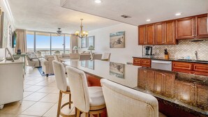 A spacious kitchen with a large island, wooden cabinets, and a view to the outside. - 1004 Waters Edge Resort 1 Bedroom Condo by RedAwning (Murrells Inlet)