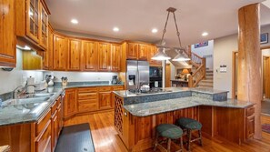 Enjoy cooking in this well-equipped kitchen with a large island, oven, and gas range.
