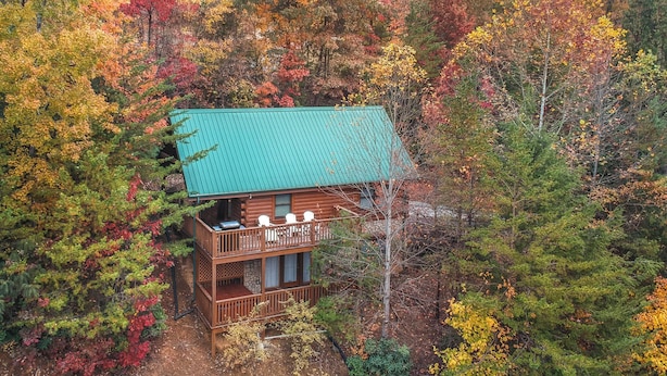 A cabin with a balcony, surrounded by autumn foliage. - Americana by Jackson Mountain Rentals (Gatlinburg)