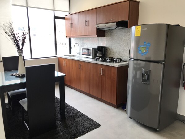 Fridge, microwave, stovetop, coffee/tea maker