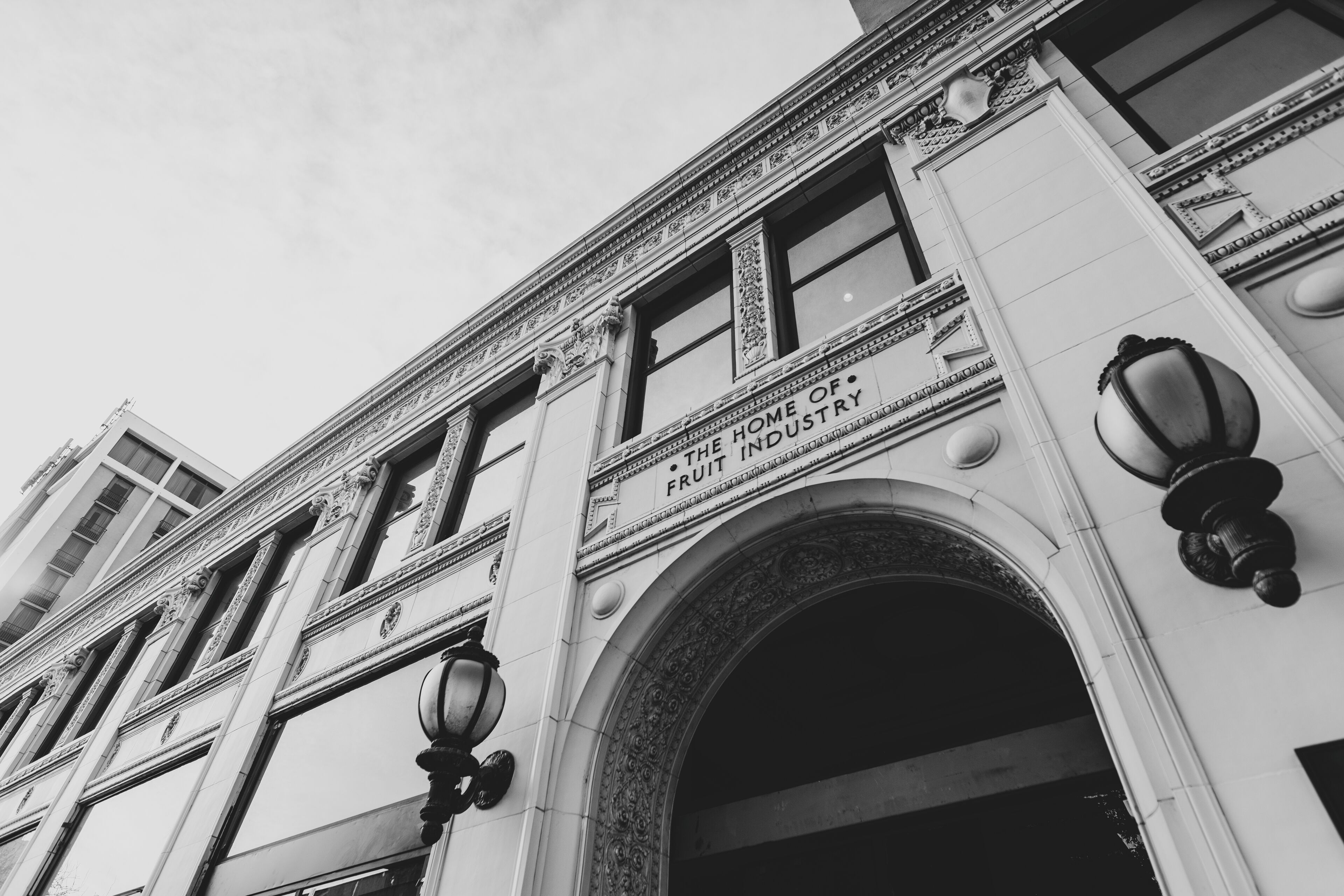 A building with ornate architectural details and a sign reading "The Home of Fruit Industry".